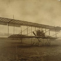 Farman-type airplane in field