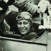 Pioneer aviator Amy Johnson in cockpit with toys