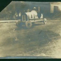 Blurry childhood photo of Bill Milliken in wooden car