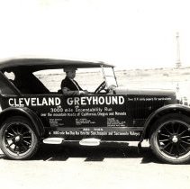 Photograph of Hart Brandon at the wheel of "Cleveland Greyhound", ca. 1923