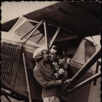 French photo postcard: Woman holding flowers, man in Potez 36, flirting