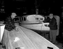Working on boats in a cannery building, March 1953