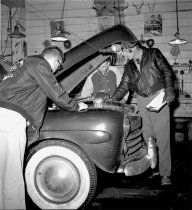 Members of the Ketchikan car club "The Outcasts" working on a car