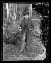 Young man in long coat and bowler