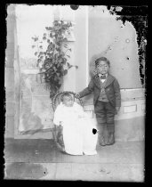 Young boy and baby in rocker