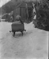 Alice Hillard sitting in a sled