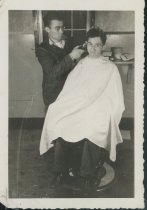 24.26.005, Album, Photograph, Bob McKay cutting Hartman Rice's hair_1940s