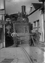Train engine being transported on a flatcar, 1930