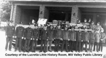Men in front of fire truck and fire station; date unknown; B&W