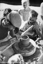 Potter throwing clay at Fall Arts Festival, date unknown