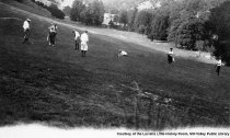 Golf course with players, c1925