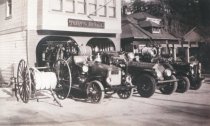 Fire trucks outside of fire station, early 1900's