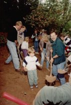 Adults and children digging with shovels at groudbreaking for library addit