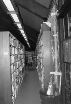 Water leak next to library shelves, 1984 or 1985
