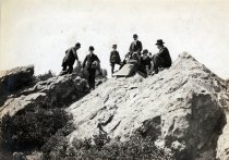 Seven hikers atop a lookout rock on Mount Tamalpais, circa 1900