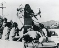 Tam High students in parade in a vehicle with model of clock, circa 1968
