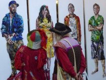 Fall Arts Festival goers viewing colorful art, 2019