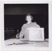Woman posing with box of Lucky Lager beer, 1956