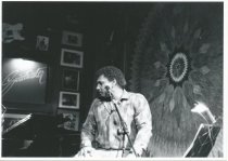 Sitting on stage in front of microphone