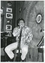 On stage, singing, at Sweetwater