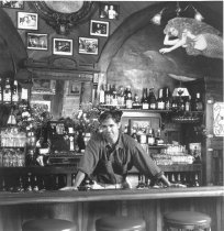 Man behind bar, date unknown