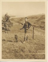 Leighton Robinson standing in a field, date unknown