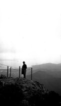Man at viewpoint East Peak Mt. Tamalpais with Richardson Bay in background.