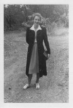 Woman standing outdoors, unknown