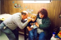 Unidentified PA examining child with ear ache