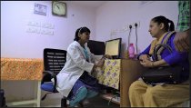 Nalla Swapna, a cardiology PA, talks with patient at her clinic in India