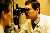 AAPA Promotional Photos - Man Checking Male Patient's Eyes, undated