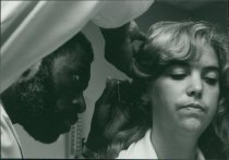 John Davis (?) examines a patient