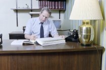 Kenneth Ferrell looking over Insurance Records, 1987