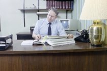 Kenneth Ferrell looking Taking Notes on Insurance Records, 1987