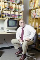Victor Germino at his desk in his office at Duke University, 1987