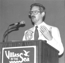 Alan Sams Presenting at Podium During GAPA Meeting, undated