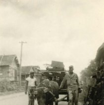 Filipino Man, American Soldier & Carabao Pulling a Cart; Philippine Islands