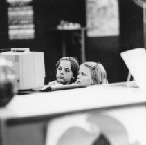 Children look at a filmstrip viewer