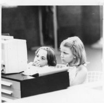 Children look at a filmstrip viewer