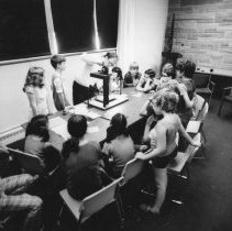 Children sit around table learning filmmaking