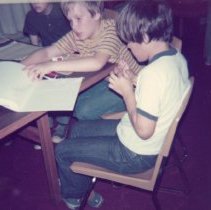 Children work on filmmaking crafts together