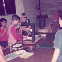 Children take turns using machine
