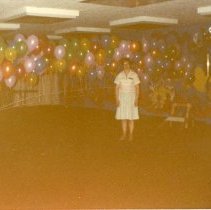Rita Ann Bert stands in front of balloons