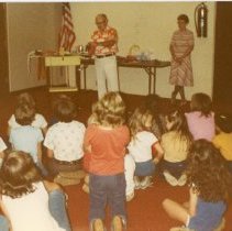 Bill creating balloon animals for children