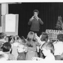 Children following along during Christmas celebration