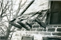DeTurk House, view of damage to pent roof & outlookers (c.1974-1975)