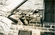 DeTurk House, view of damage to pent roof (c.1974-1975)