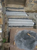 0064--:Screening caps on channel drain mortar joints.