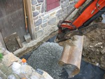 2640--Loading "2B" clean stone onto geo-textile fabric.