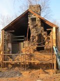 Chimney with temporary shoring during reconstruction of south gable wall
